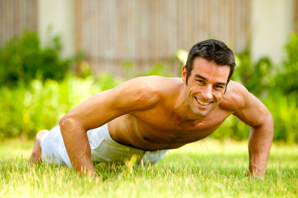 Man doing pushups on grass